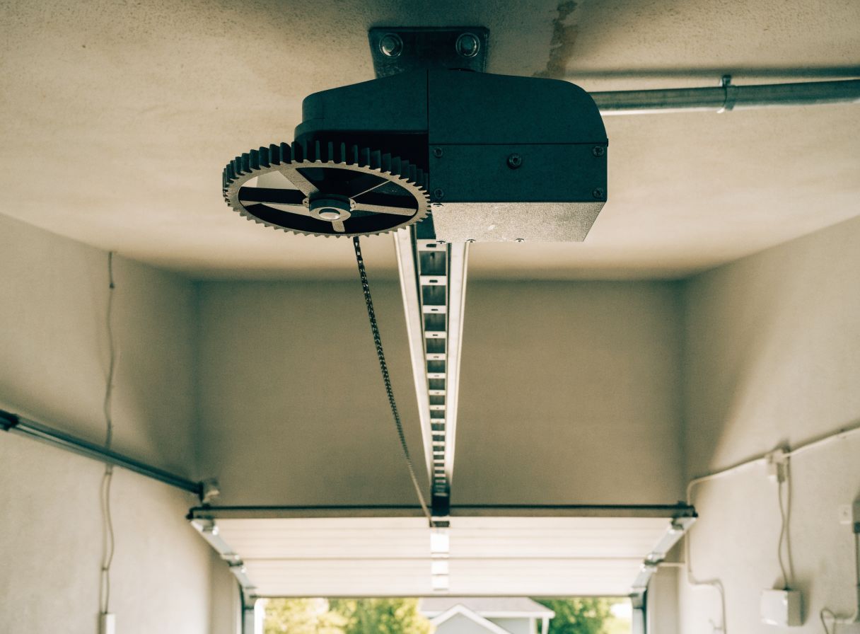 Garage door opener motor unit mounted on the ceiling rail